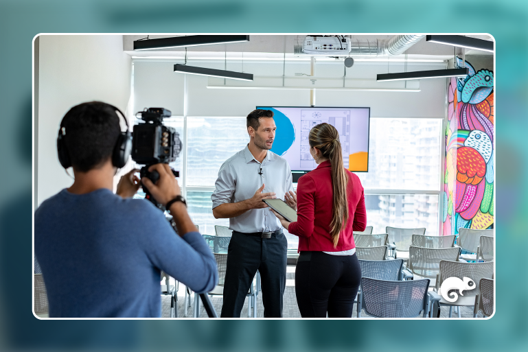 Two people in an office being recorded for a video